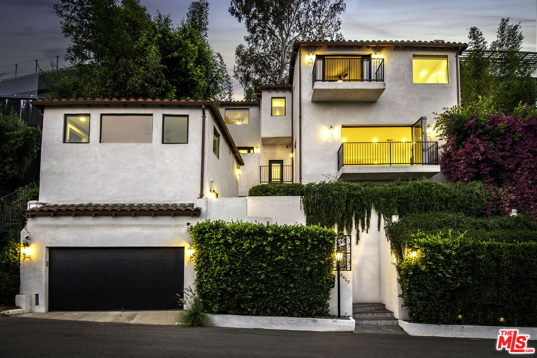 a front view of a house with a yard and a garage