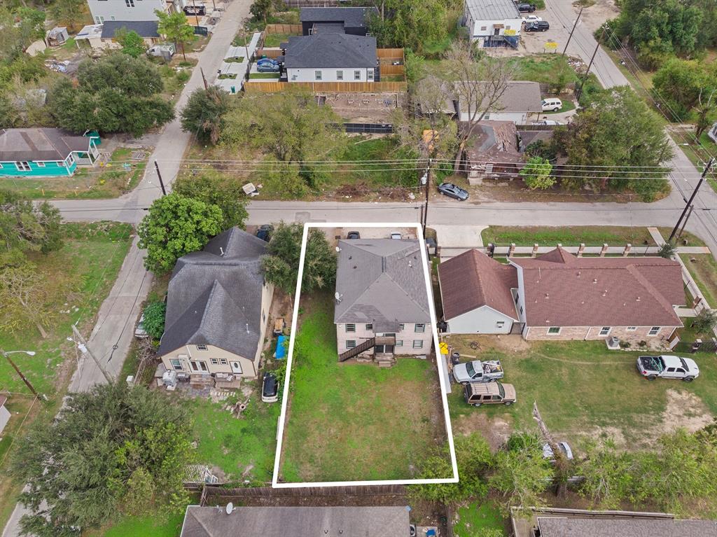 an aerial view of residential houses with outdoor space and parking