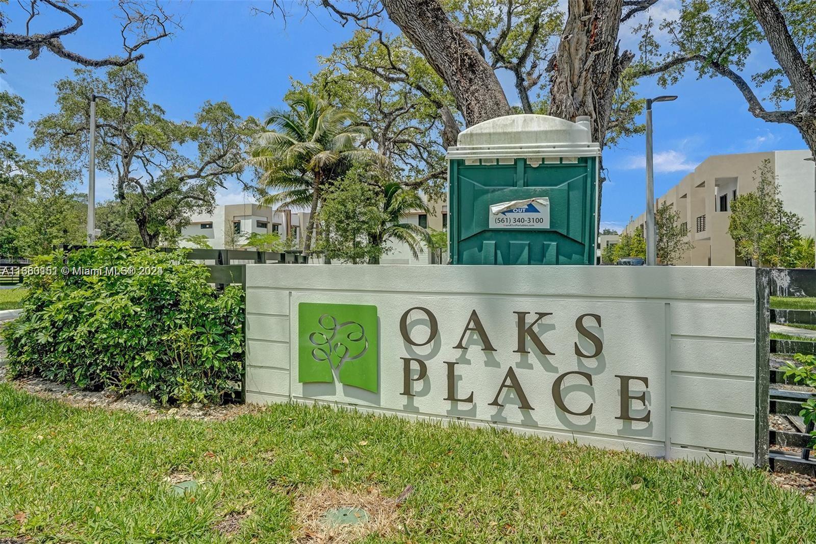 a view of a door with a sign and a garden