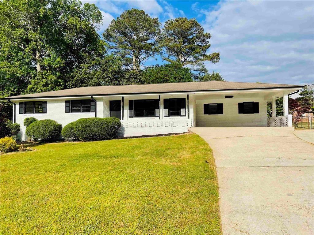 a front view of house with yard and tree