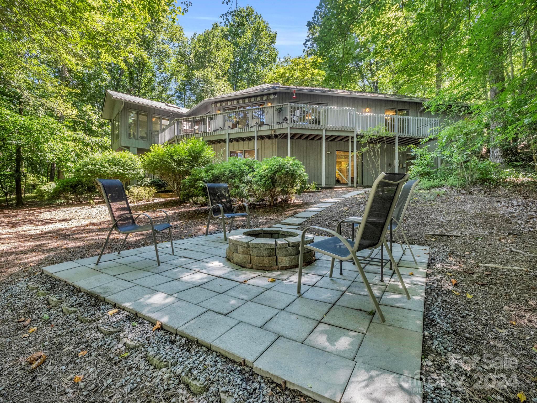 a backyard of a house with table and chairs