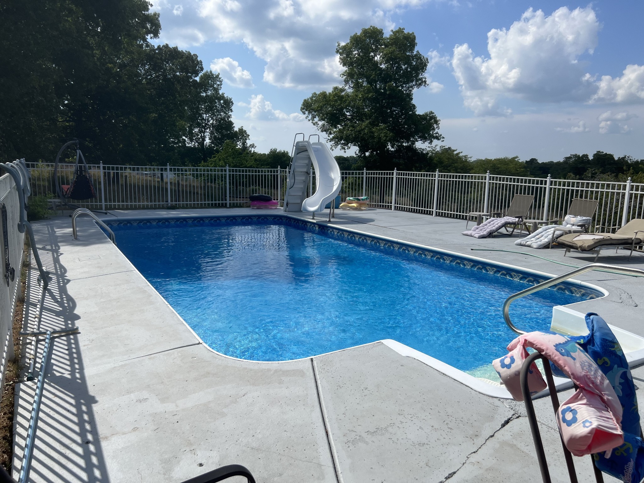 a view of a swimming pool with a lounge chair