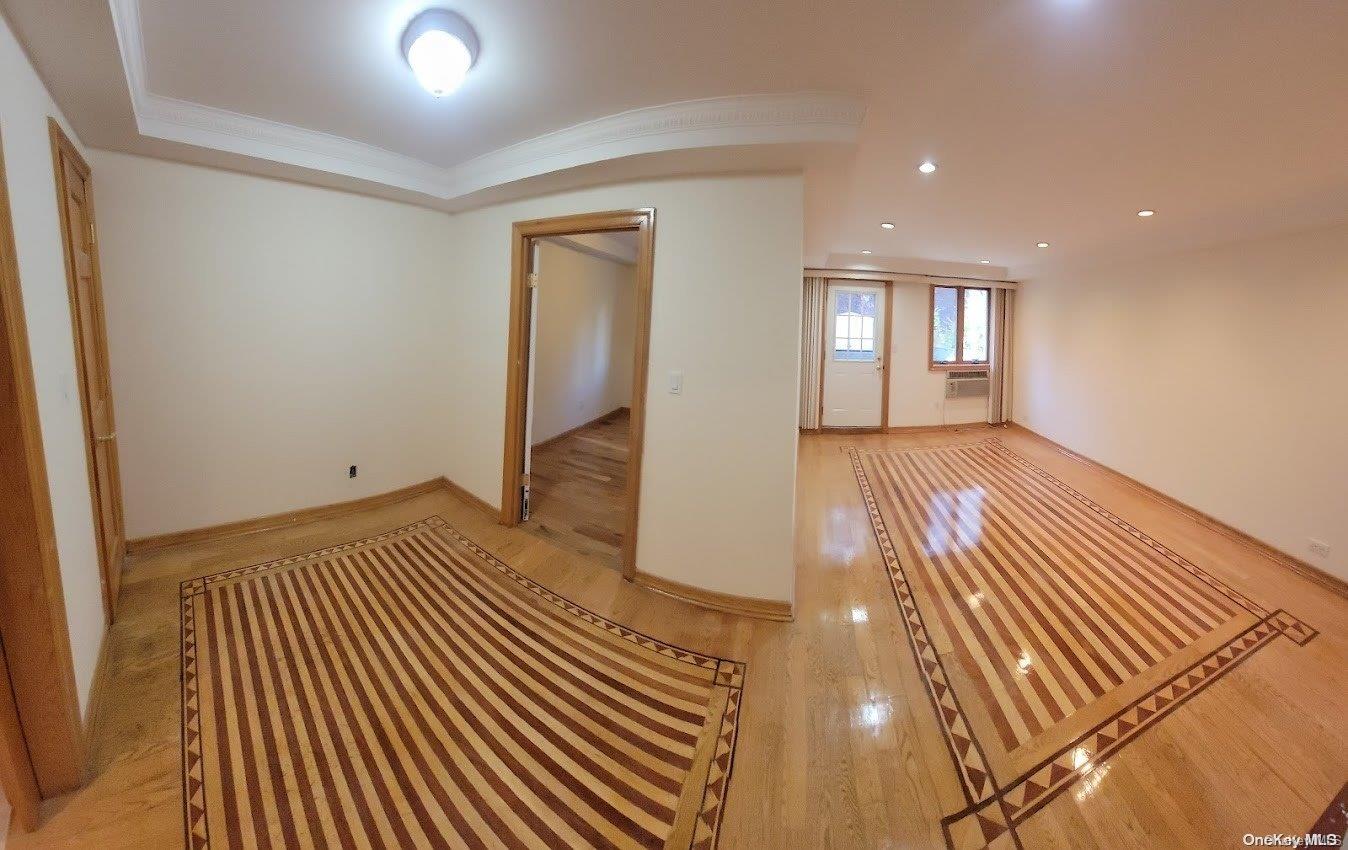 a view of a room with wooden floor