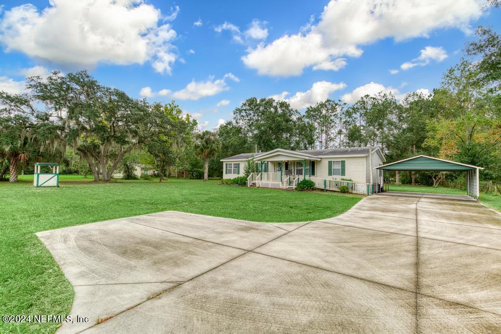 a view of a house with a yard