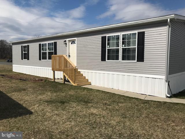 a view of house with backyard and deck