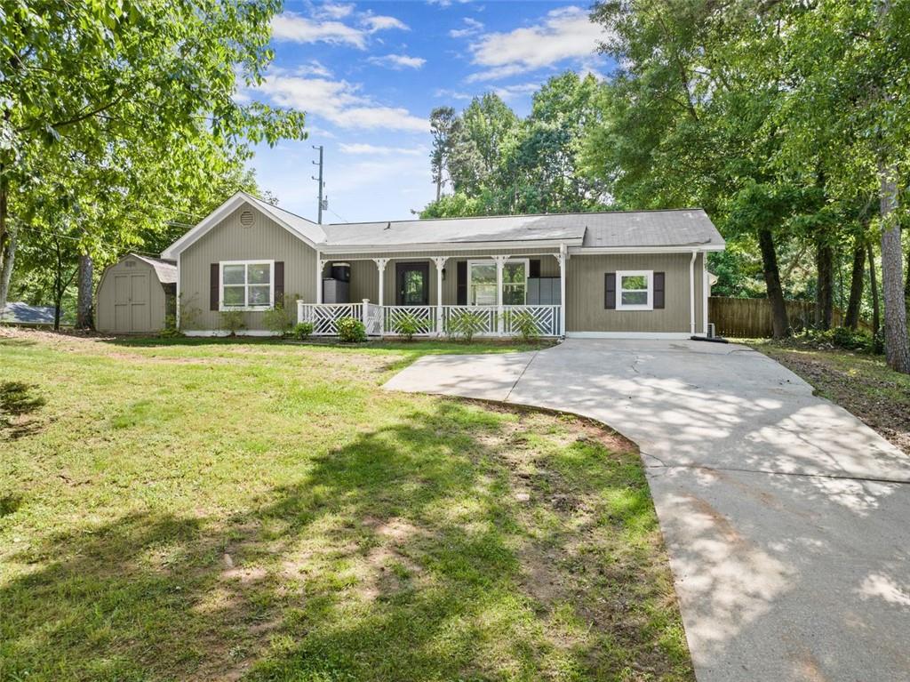 a front view of a house with a garden