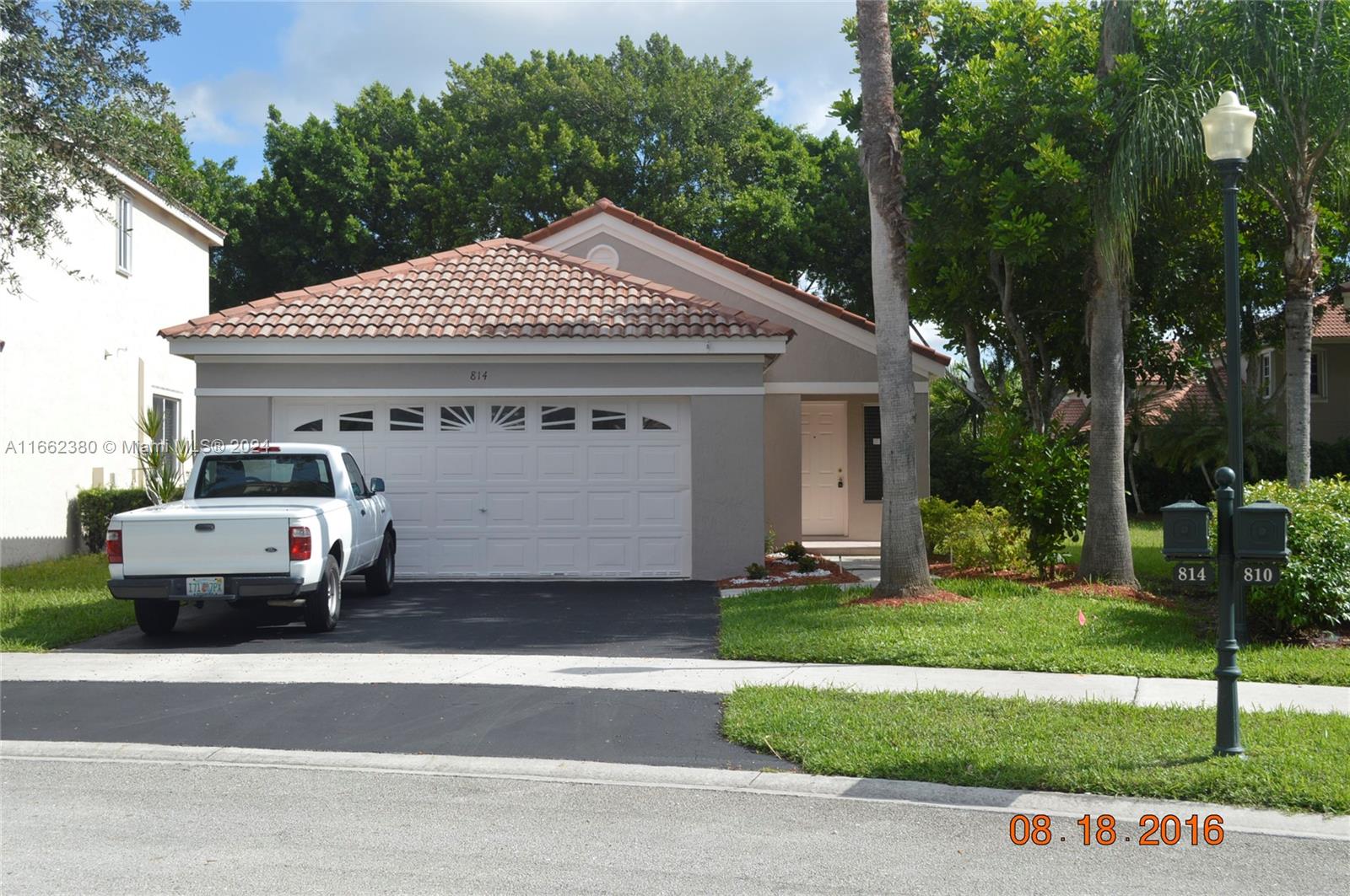 a view of a car park in front of house