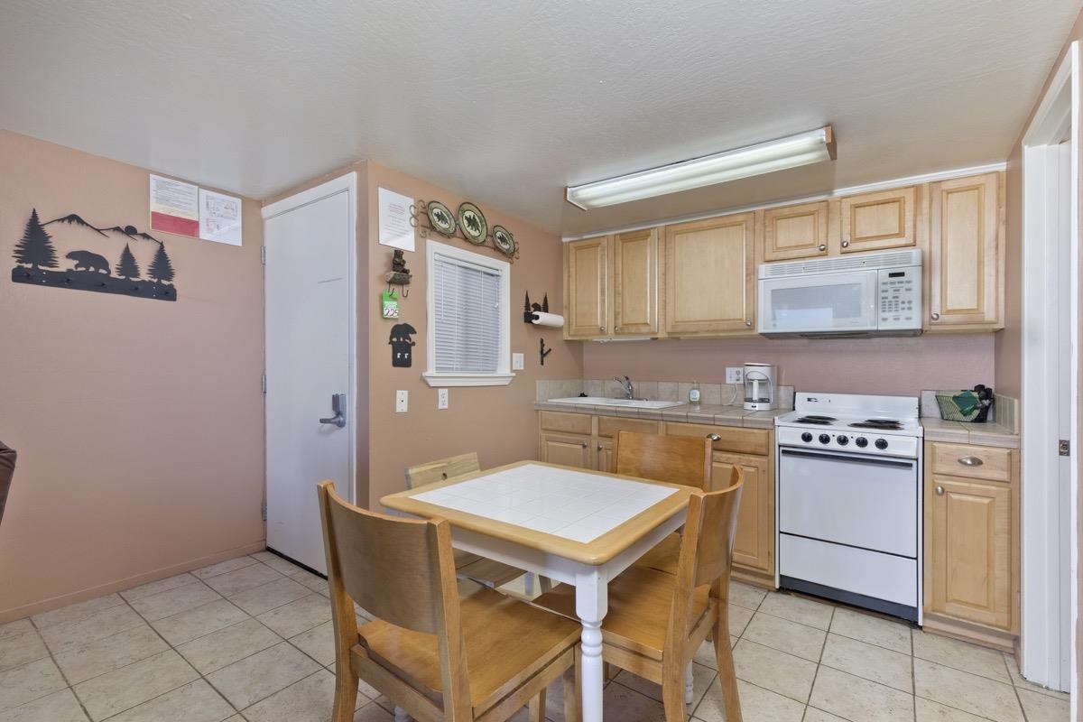 a kitchen with stainless steel appliances a stove a sink and a refrigerator