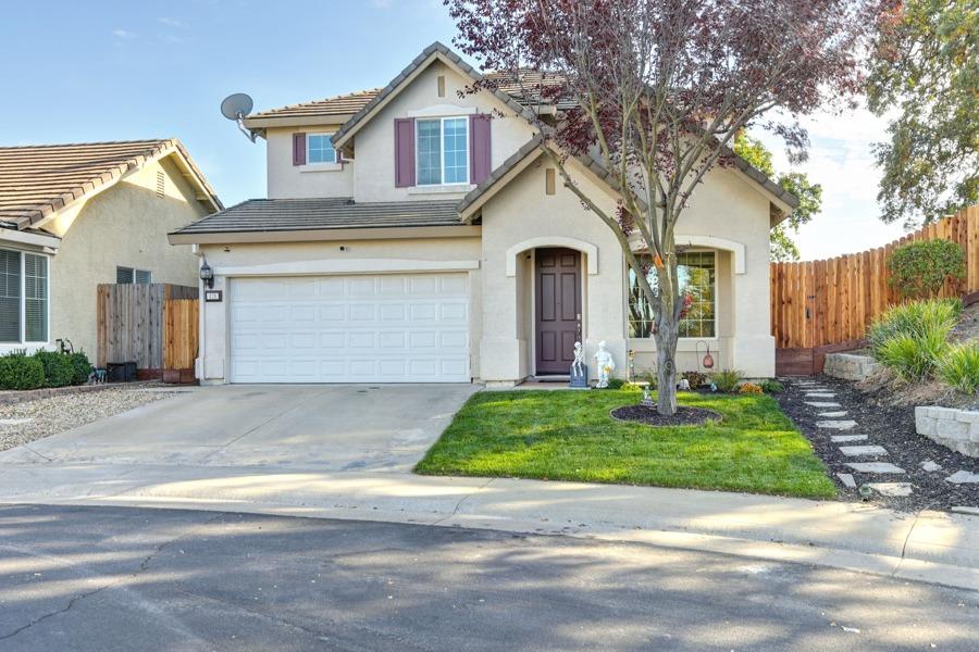 a front view of a house with a yard and garage