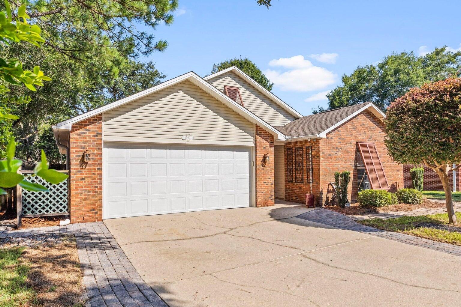 a view of a house with a yard and garage