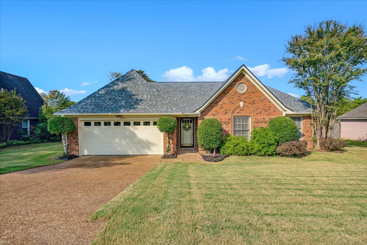 a front view of a house with garden