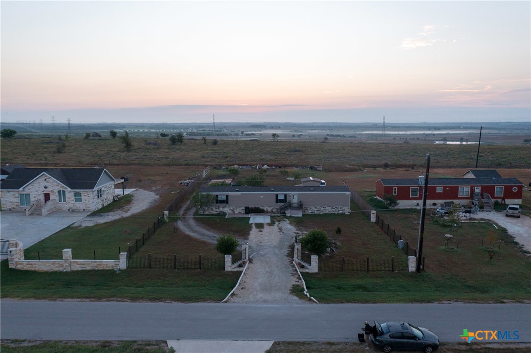 an aerial view of a house with a garden and mountain view