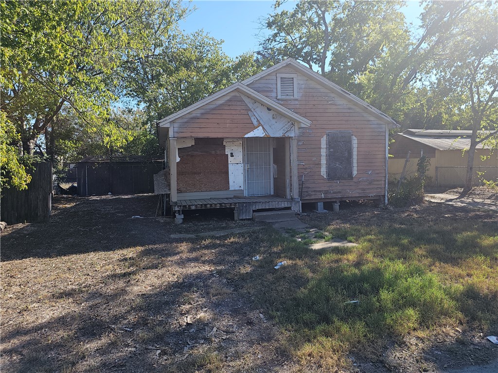 a front view of house with yard and trees