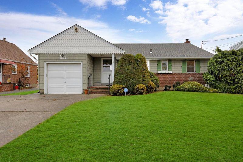 Ranch-style house with a garage and a front yard