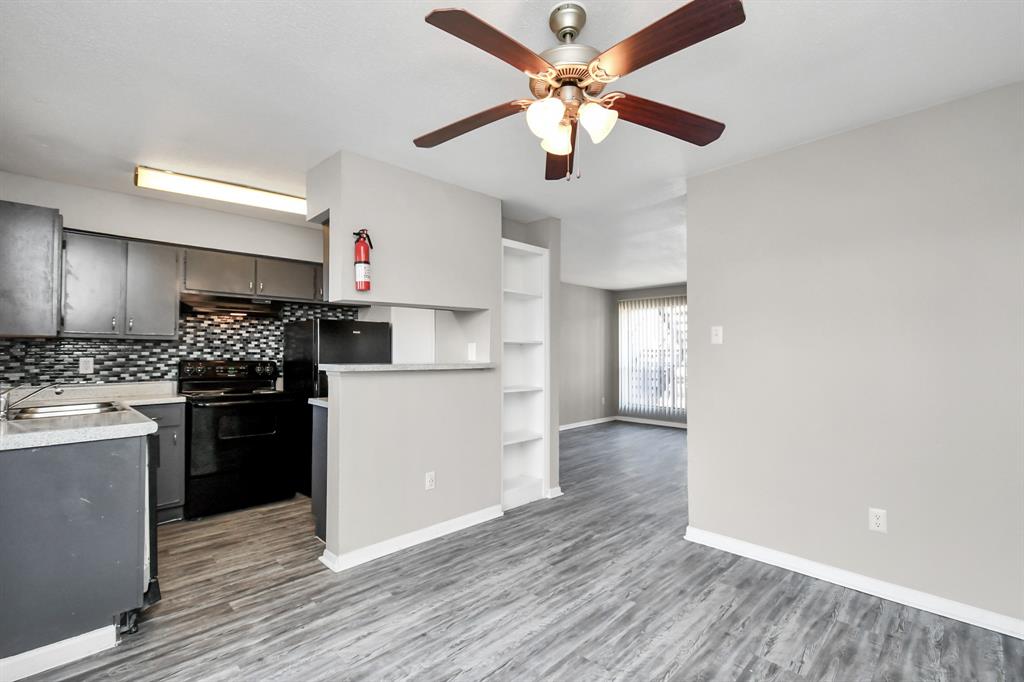 a kitchen with a refrigerator a stove top oven a sink and dishwasher