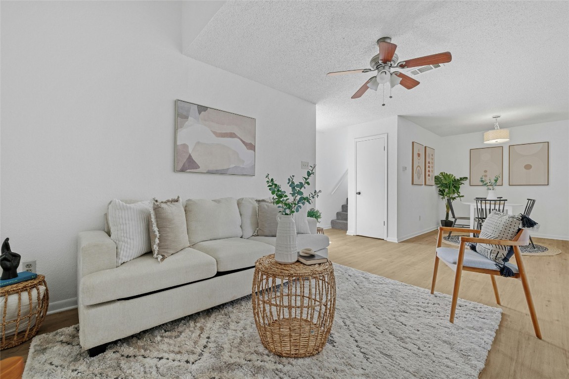 a living room with furniture and a chandelier