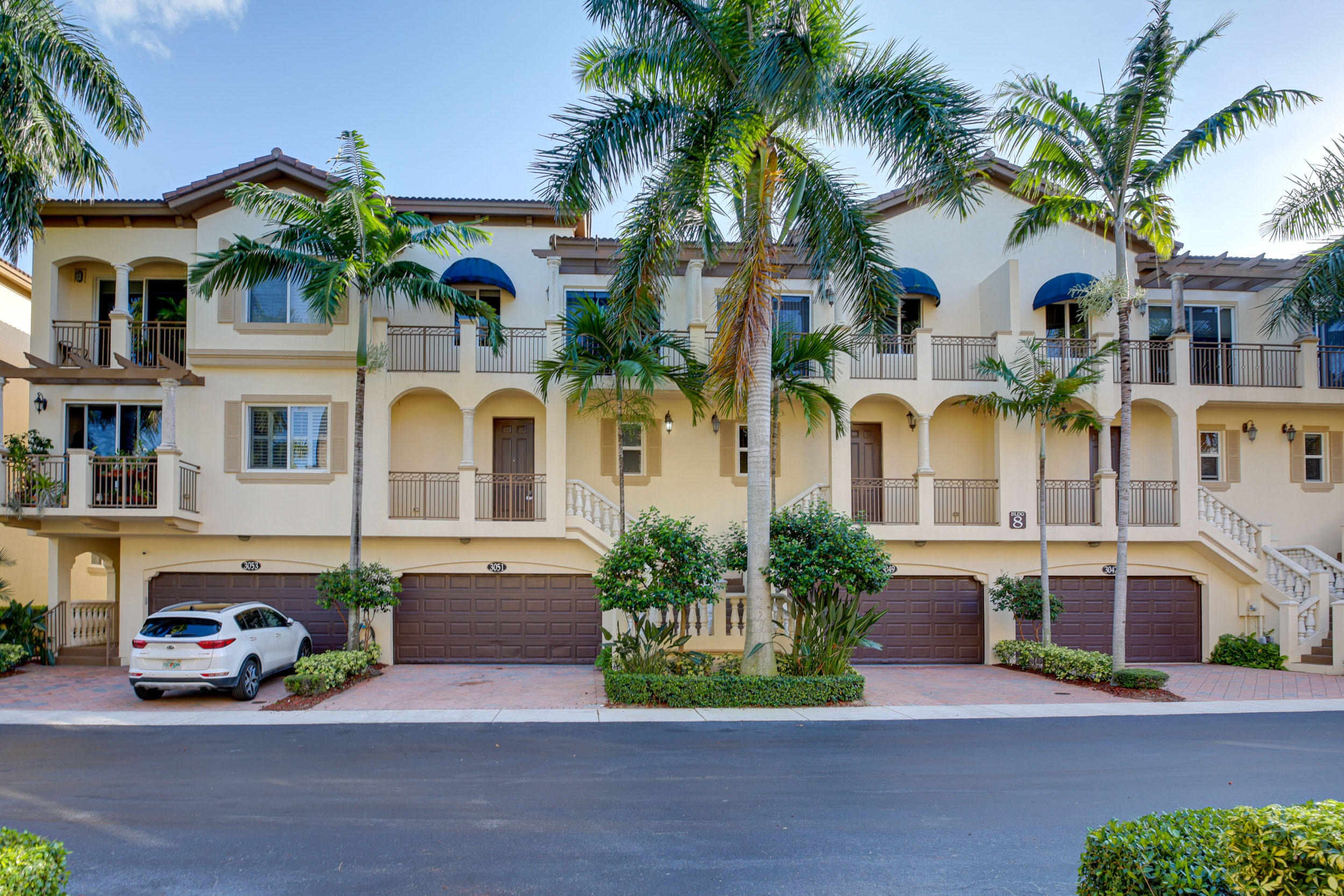 a front view of multiple houses with yard