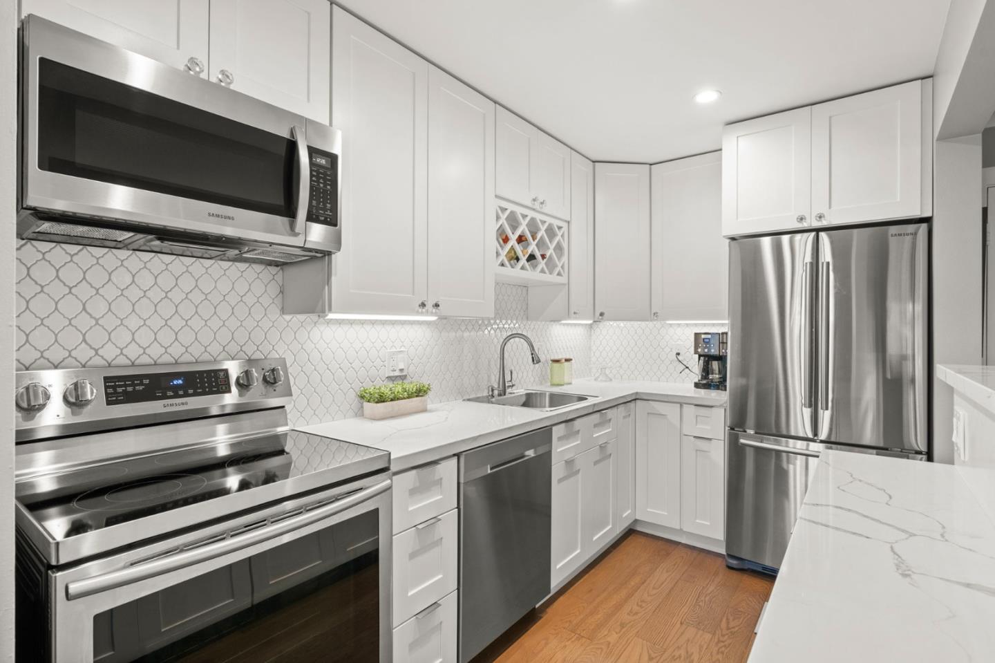 a kitchen with a sink stainless steel appliances and cabinets