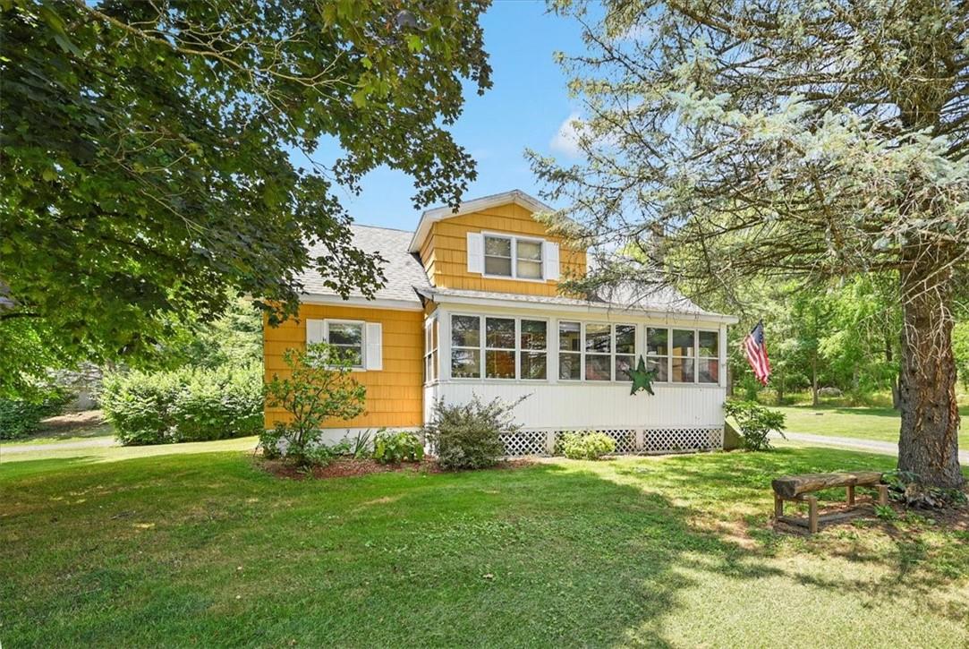 a front view of a house with a garden