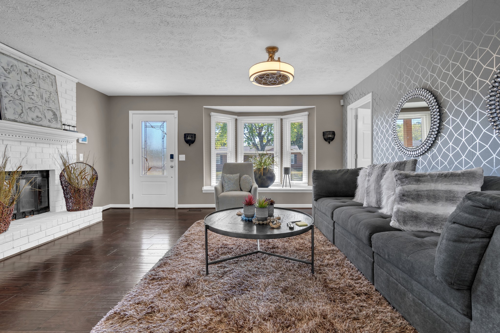 a living room with furniture and a fireplace