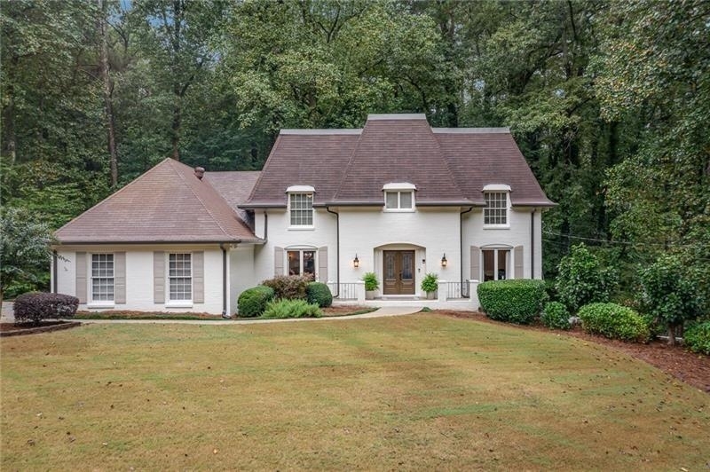 a front view of a house with a yard