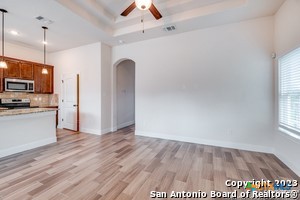 a view of kitchen with refrigerator microwave and wooden floor