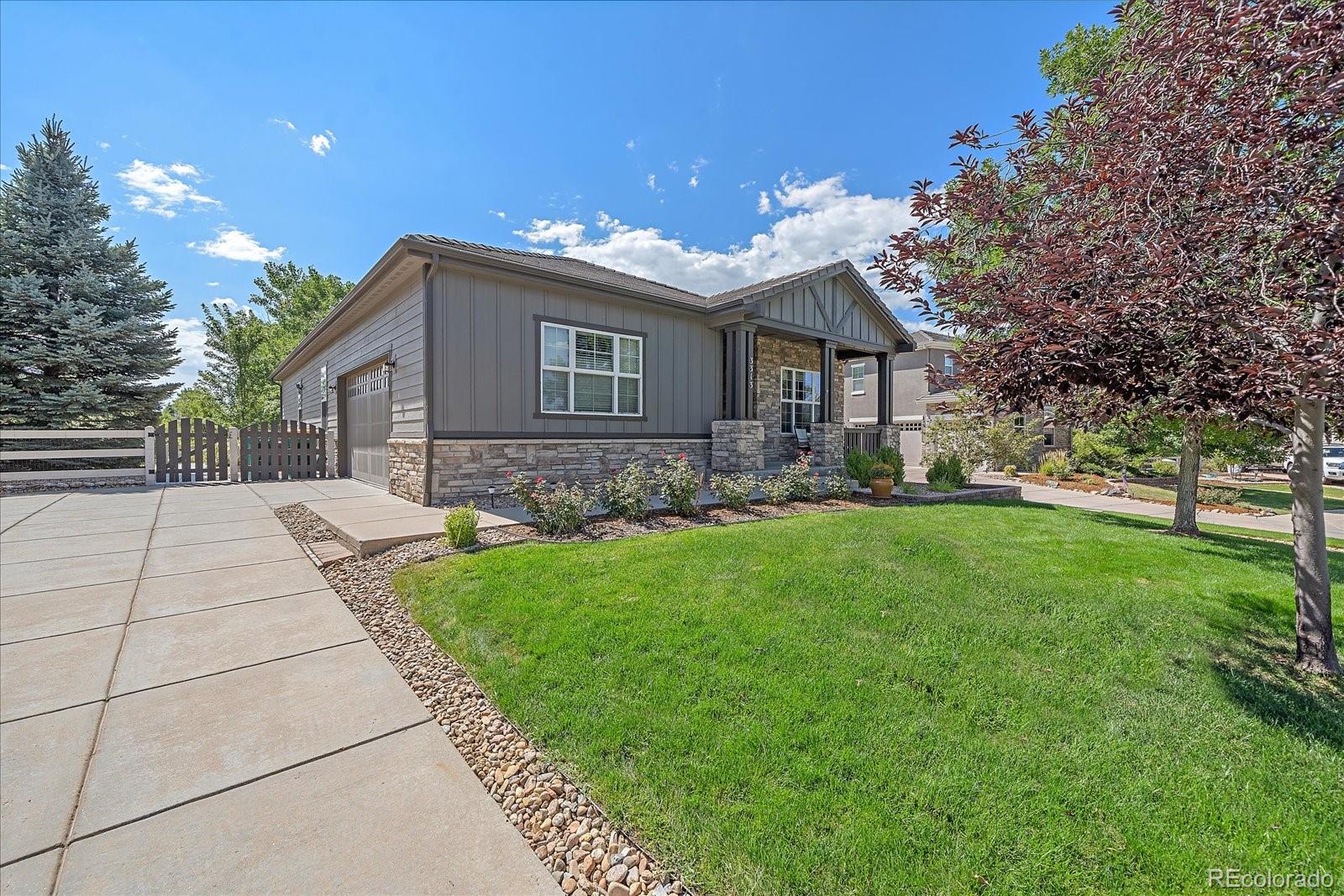 a front view of house with yard and green space