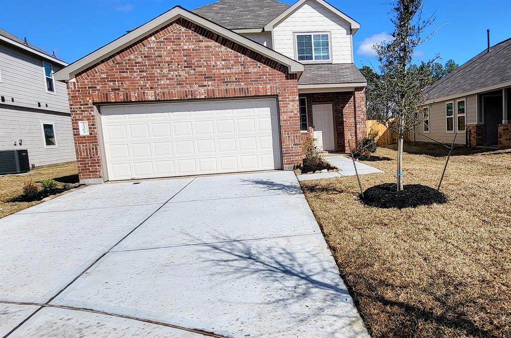 a view of a house with backyard and parking space