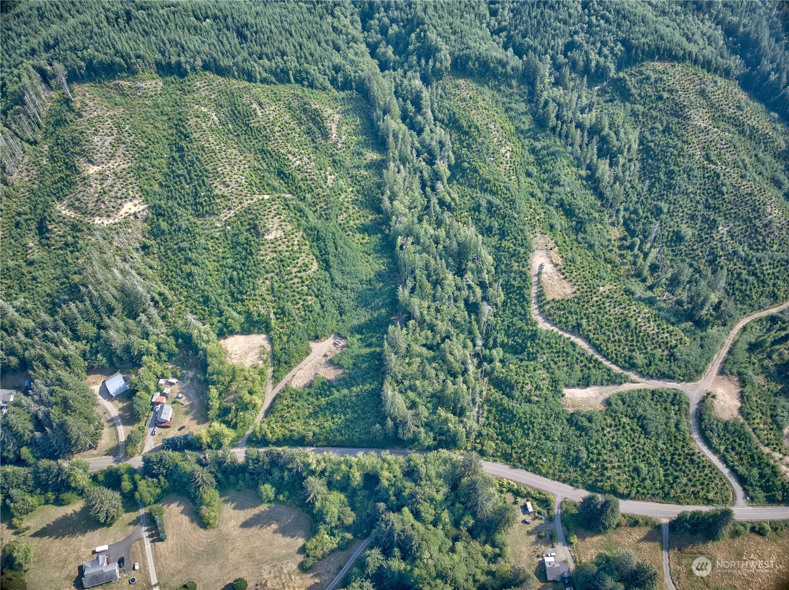 an aerial view of residential house with outdoor space and trees around