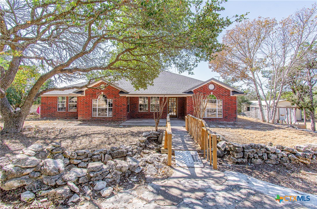 a front view of a house with a yard covered in snow