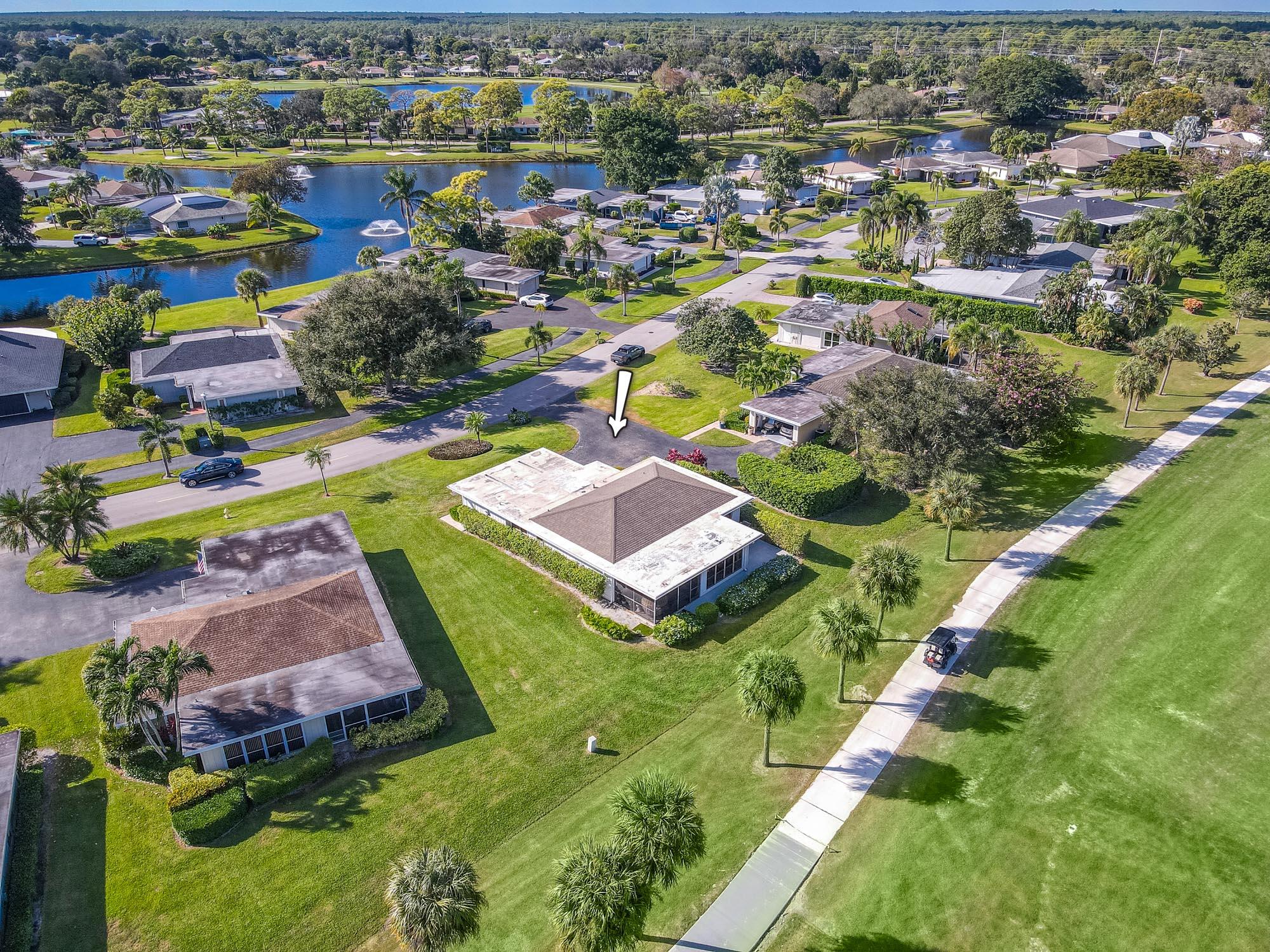 an aerial view of residential houses with outdoor space and swimming pool