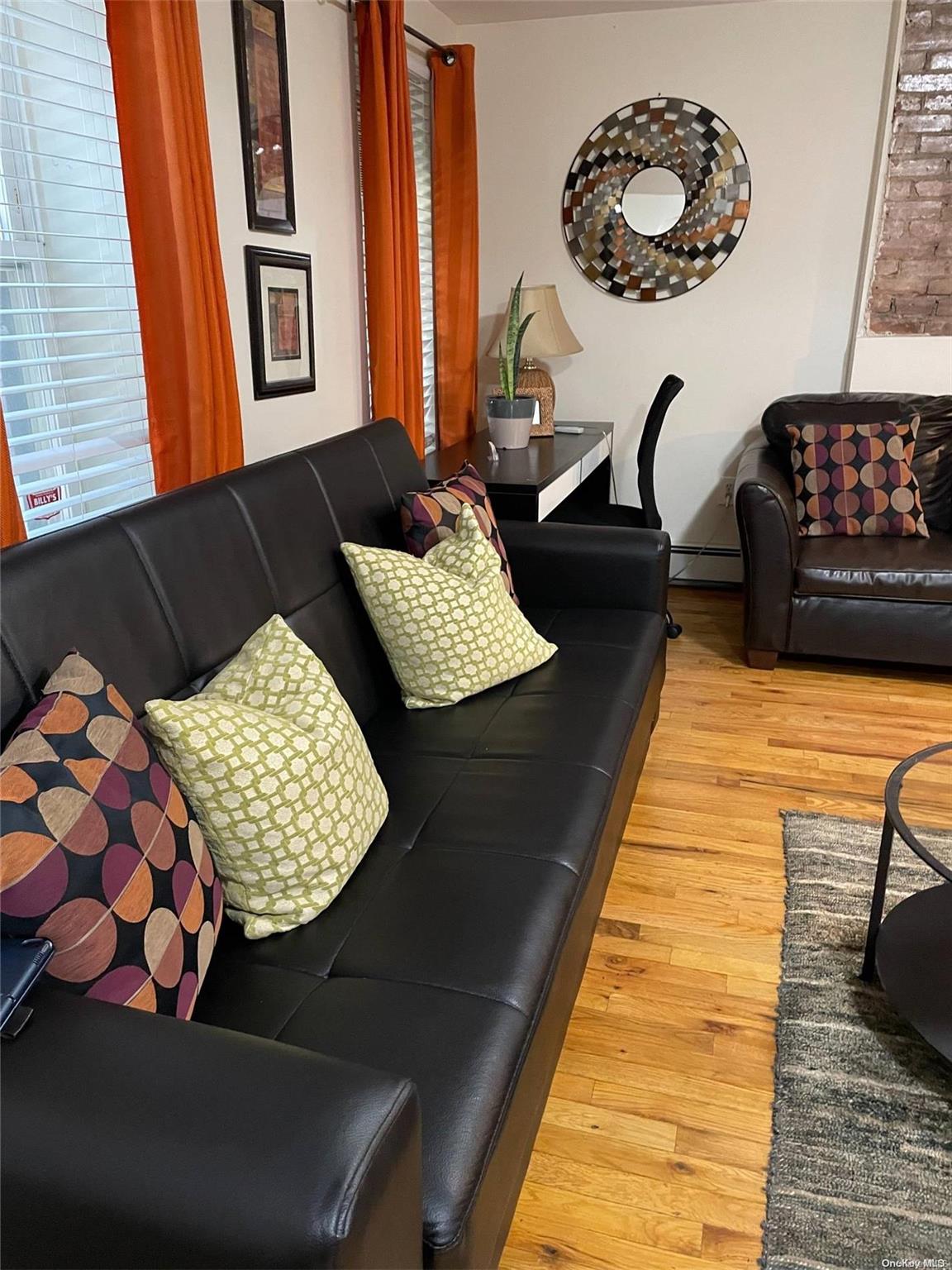 a living room with a couch and chandelier