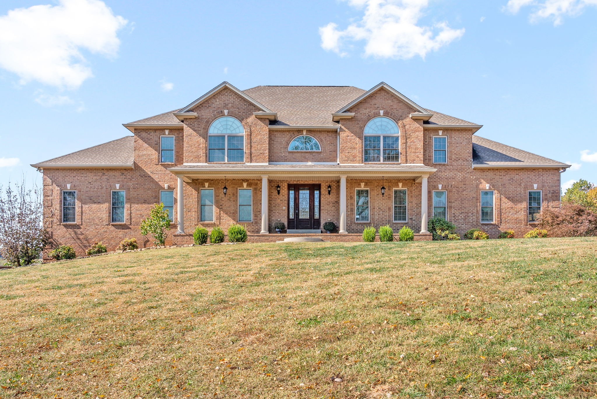 a front view of a house with a yard