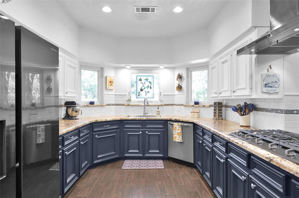 The bright remodeled kitchen features all new appliances, farmhouse style sink and freshly painted cabinets.