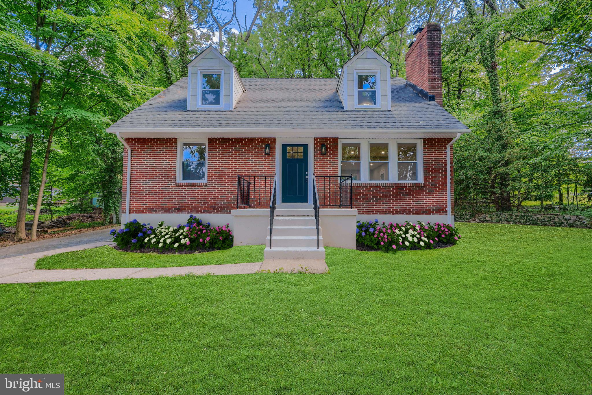 a front view of a house with a garden