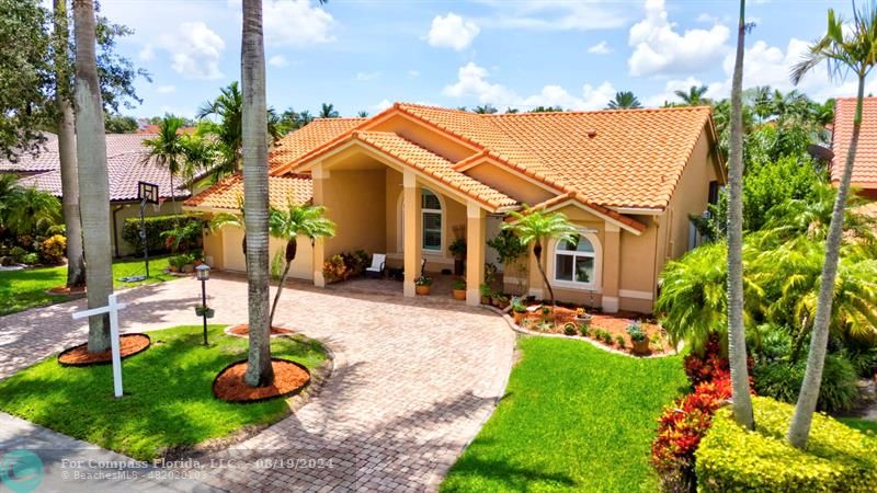 a view of a patio with table and chairs potted plants and palm trees