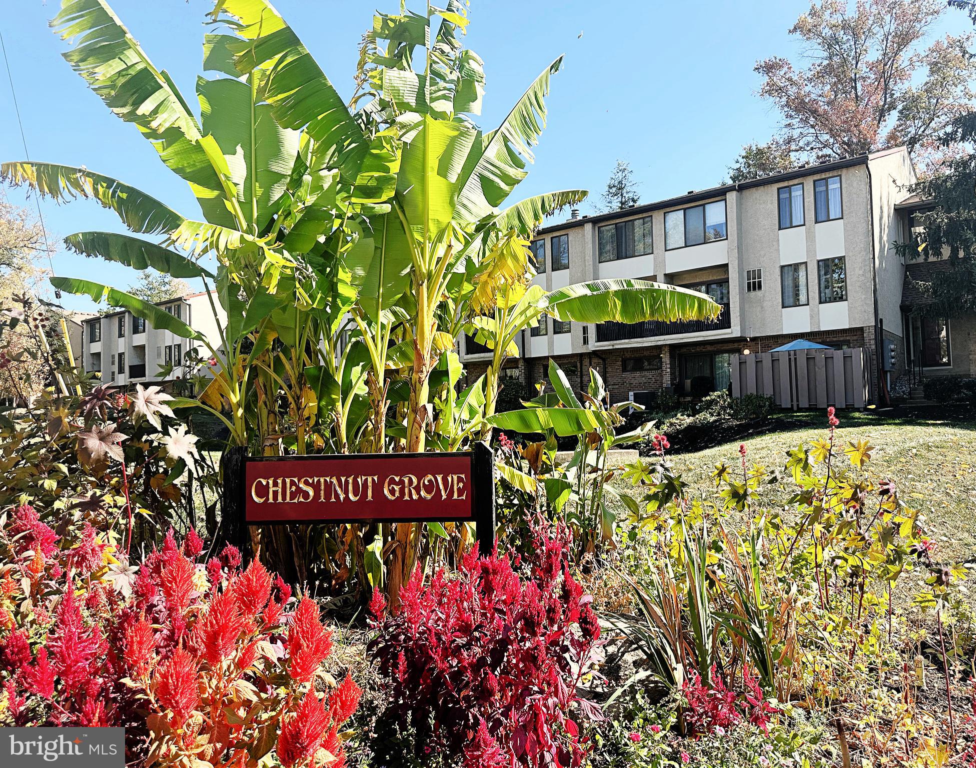 a view of a sign board with buildings in the background