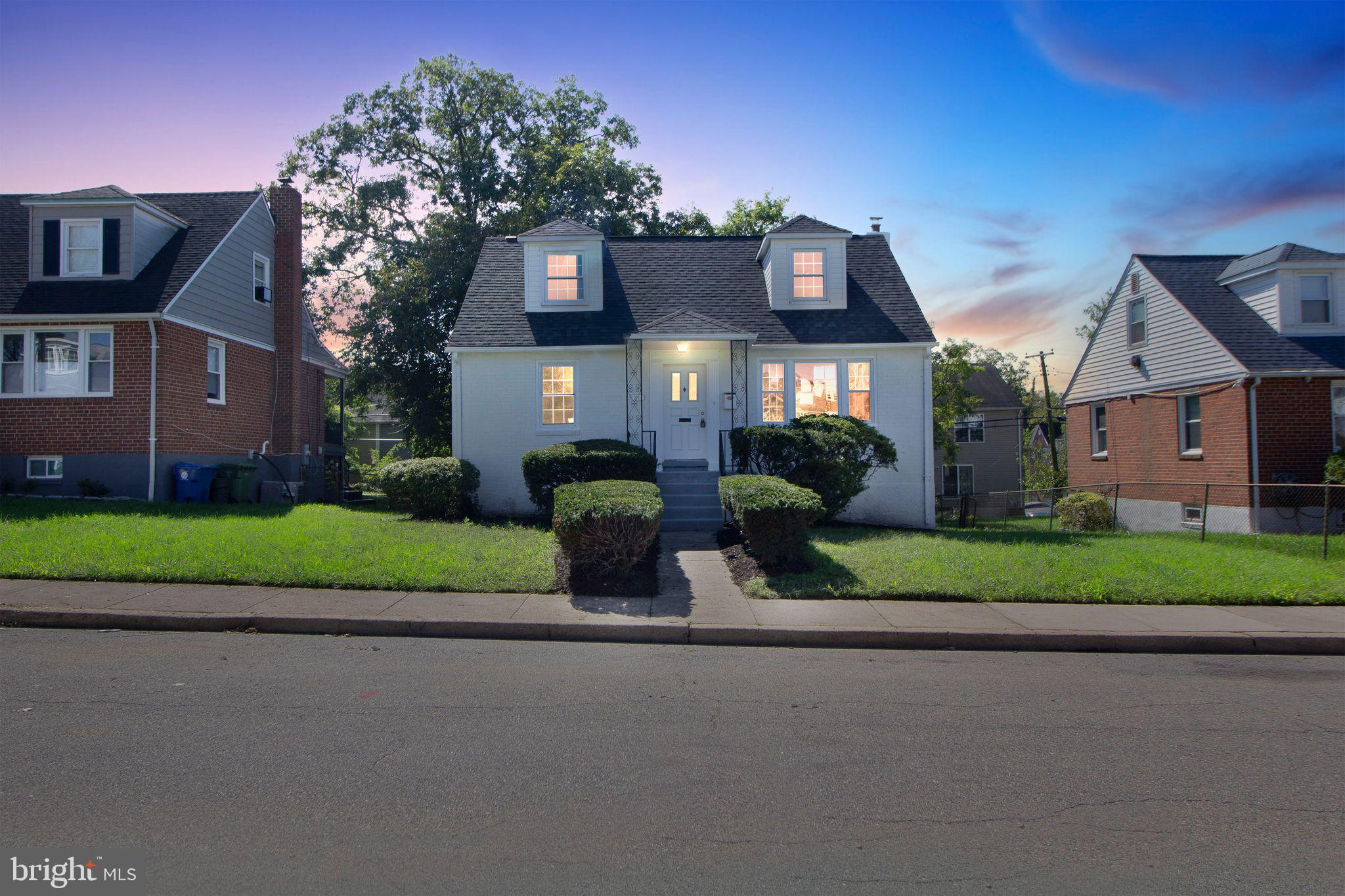 a front view of house with yard and green space