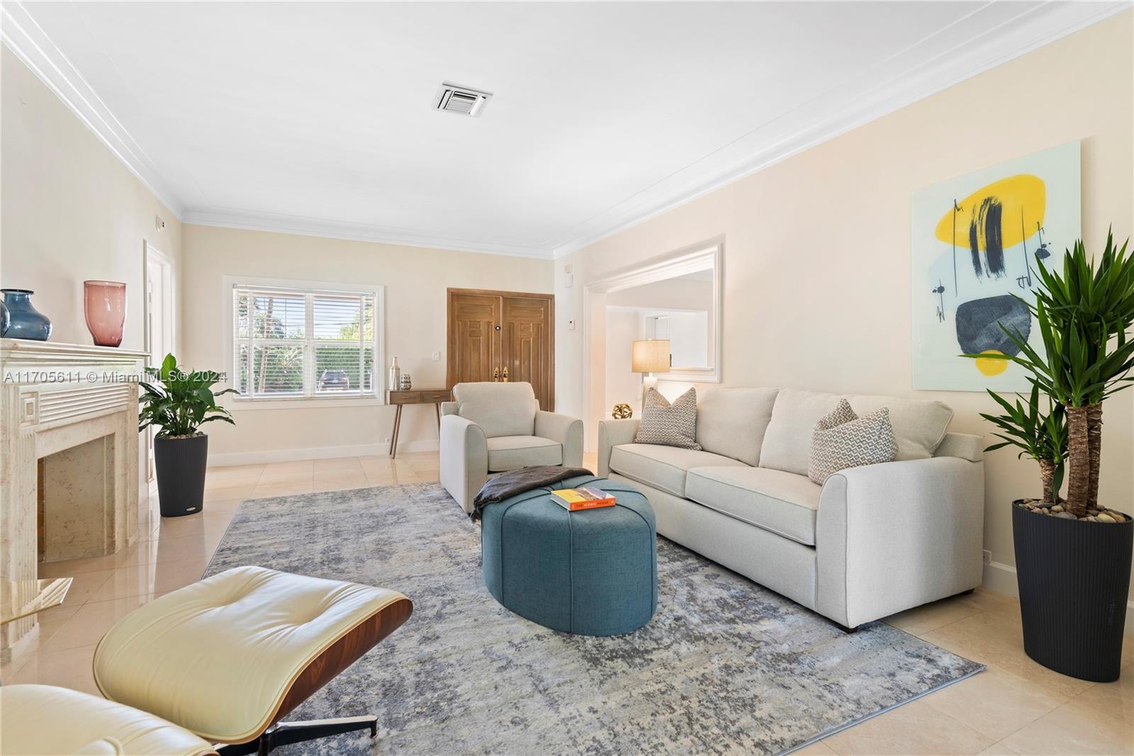 a living room with furniture and a potted plant