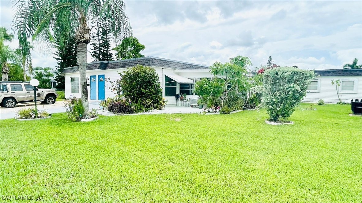 a front view of house with yard and green space