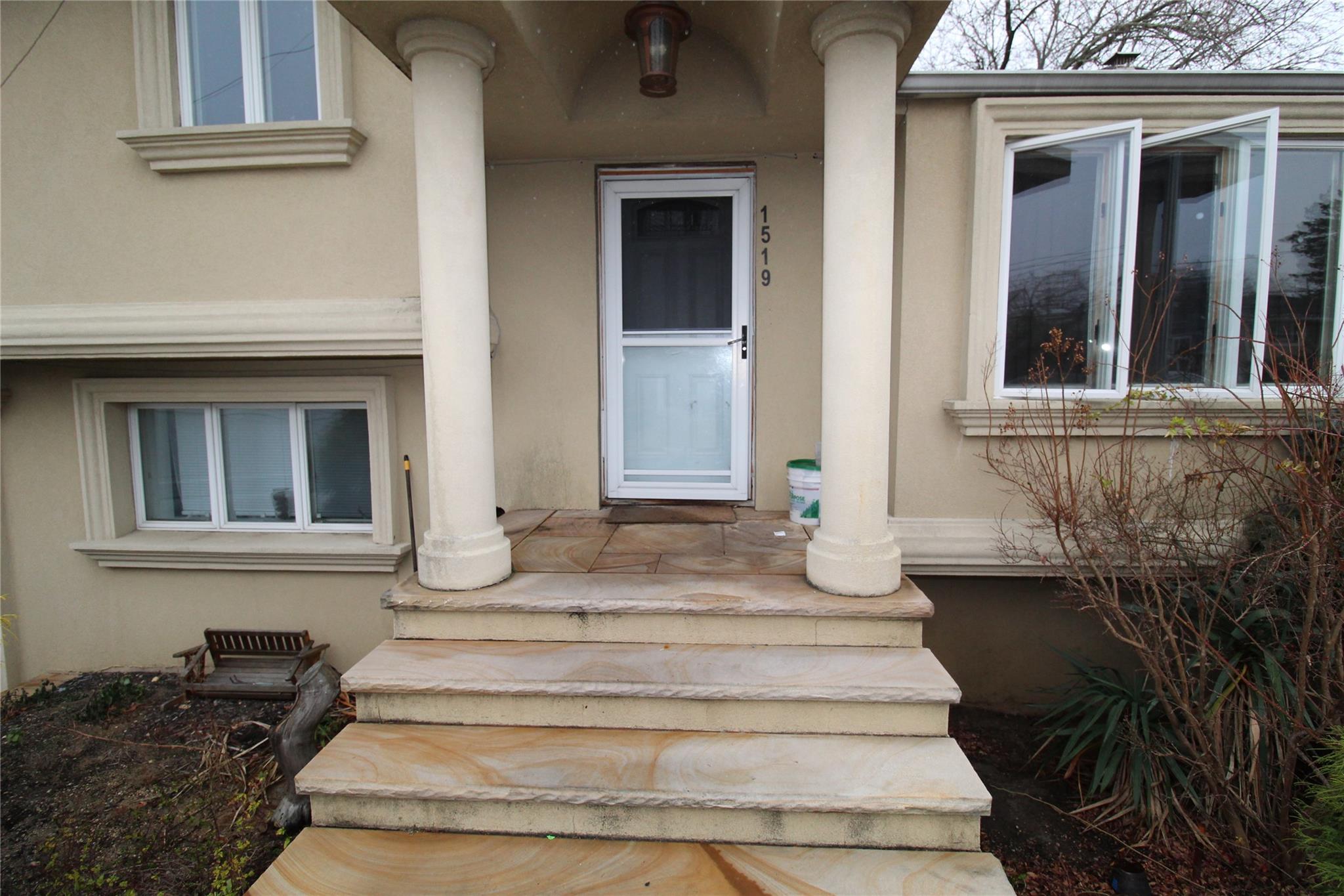 a front view of a house with potted plants