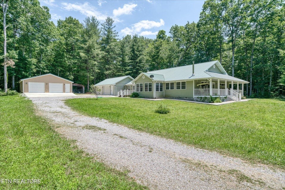 a view of a house with a yard and sitting area