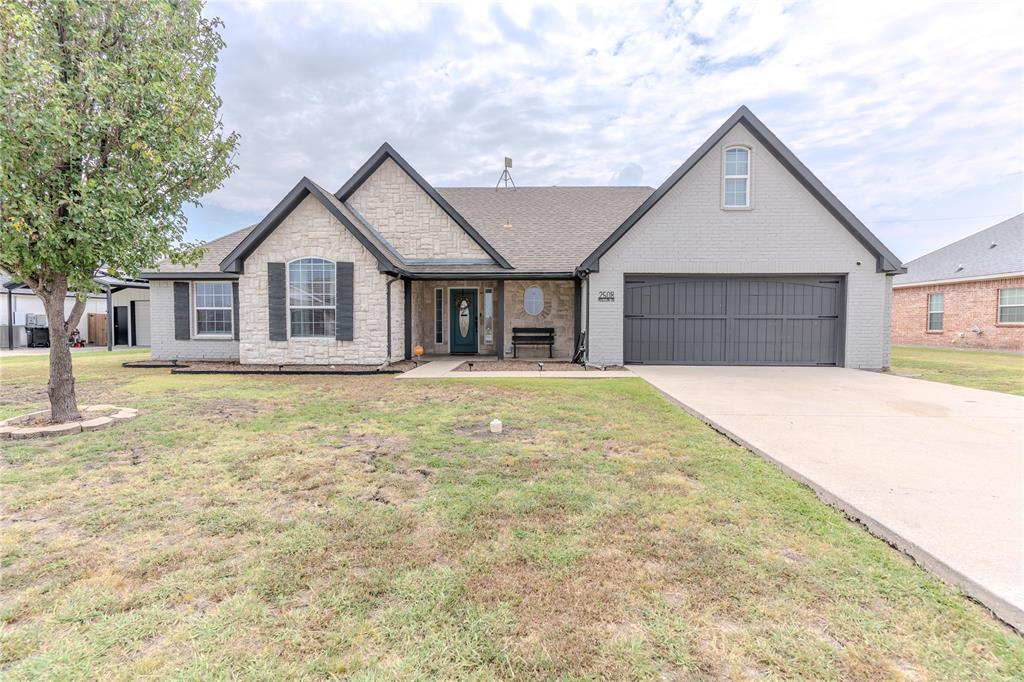 a front view of a house with a yard and garage