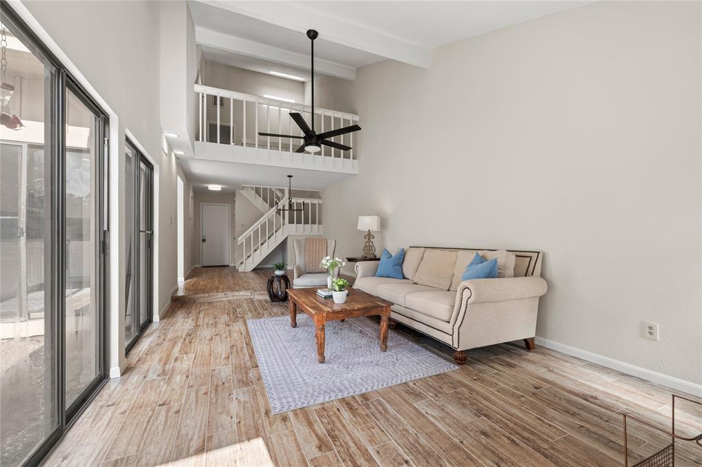 a living room with furniture and wooden floor