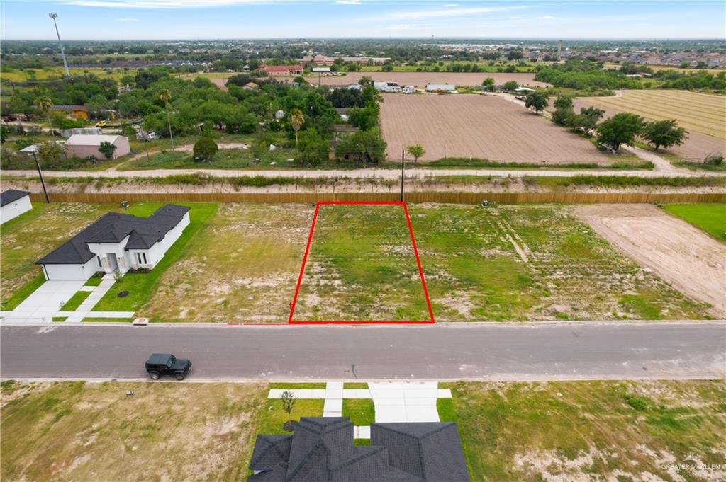 an aerial view of residential houses with outdoor space and lake view