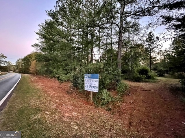 a sign board with wooden fence