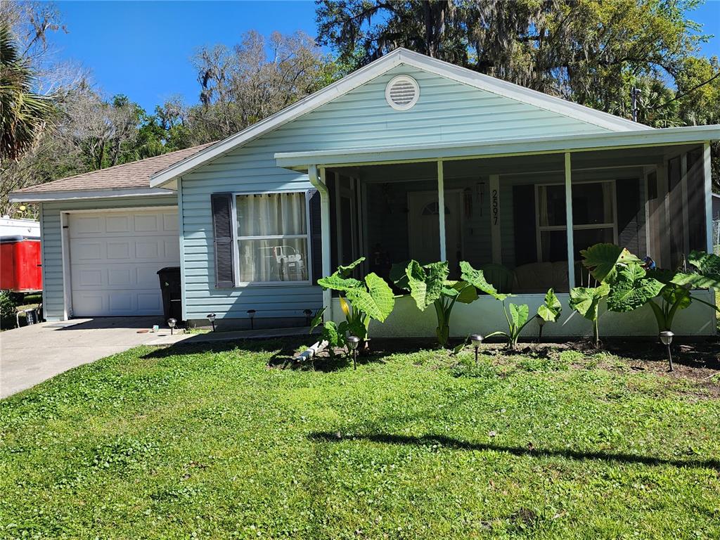 a front view of a house with a garden and porch