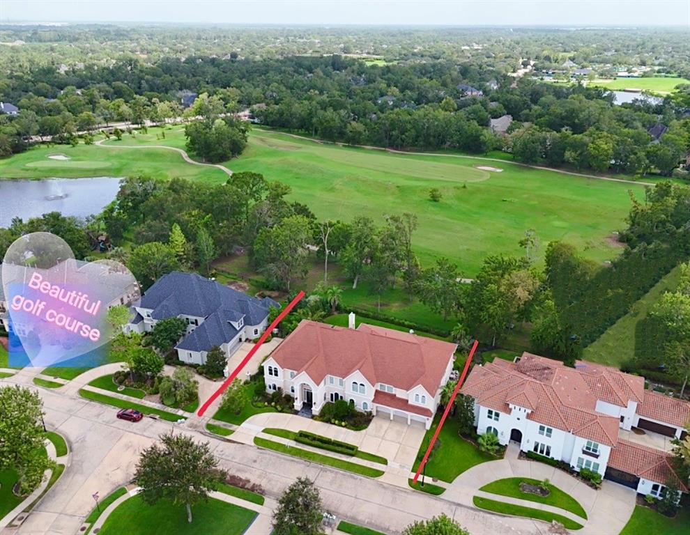 an aerial view of residential houses with outdoor space and street view