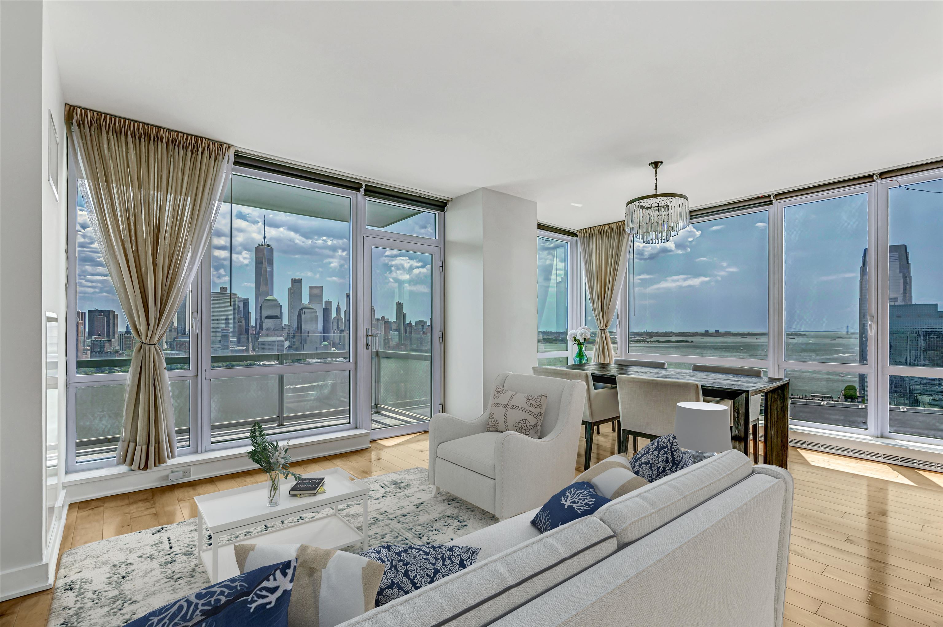 a living room with furniture and a floor to ceiling window