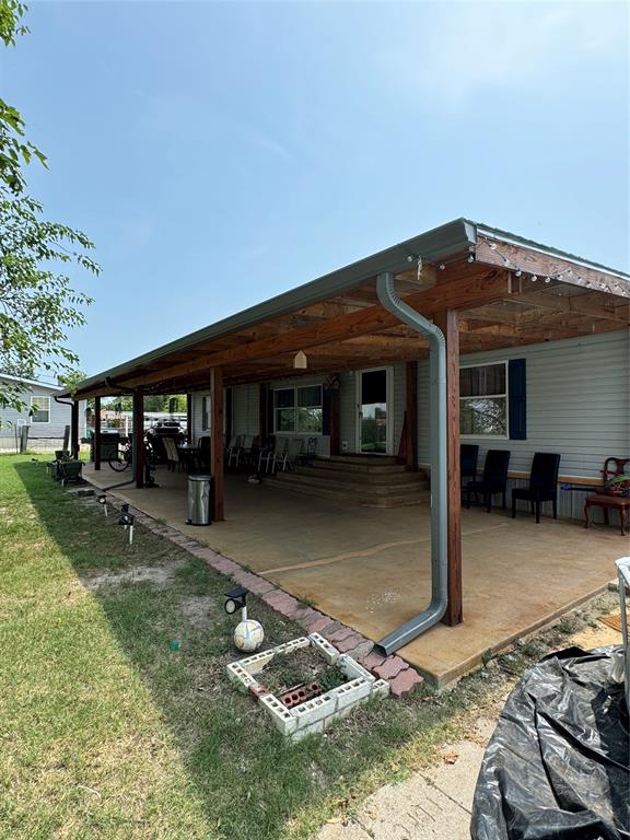 a backyard of a house with yard fire pit and outdoor seating